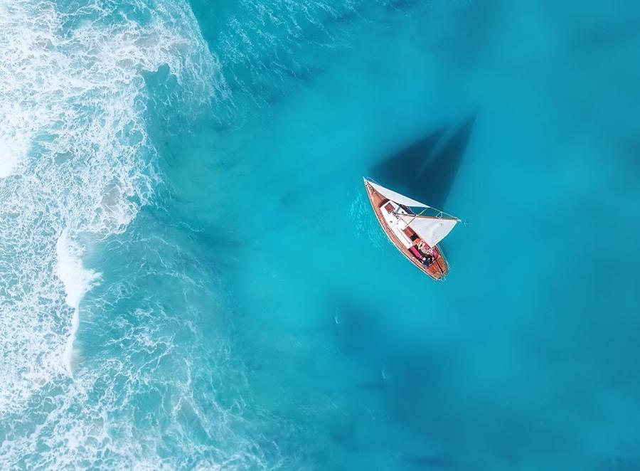 Catamaran from above on turquoise water